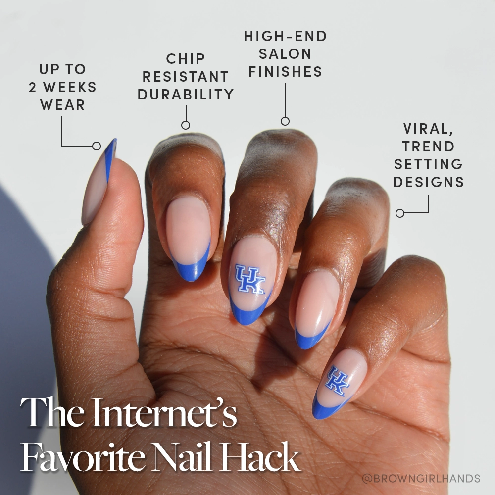 A hand with medium-brown skin wears glamnetic’s Kentucky Wildcats Press-On Nail Set, featuring royal blue French tips and UK logos. Enjoy up to 2 weeks’ chip-resistant, salon-quality nails with a high-end finish inspired by viral trends. - Product image