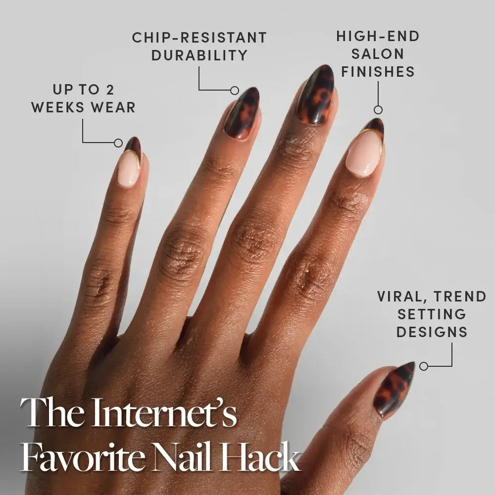 A hand with short almond nails shows off glamnetic’s KILLAZILLA Press-On Nail Set, featuring glossy tortoiseshell designs and one nude nail with a brown tip. This set promises salon-quality finishes, trendsetting style, impressive durability, and up to 2 weeks of flawless wear. - Product image