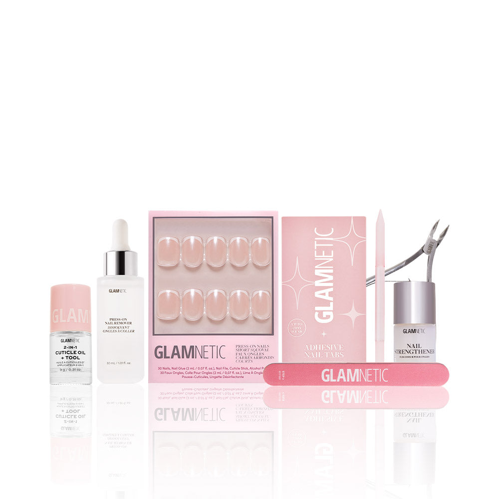 The glamnetic La Perle Manicure Masterpiece Bundle features press-on nails, adhesive tabs, nail strengthener, cuticle oil, a trimmer, file, and buffer—all showcased upright against a white background. - Product image