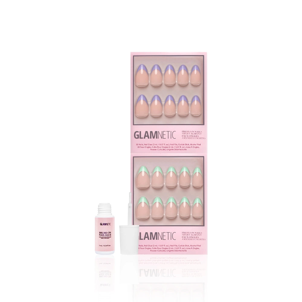 A pink box of glamnetic La Vie en Almonds press-on nails features short almond French tips in pastel mint and lilac, plus a small bottle of nail glue with cap off, all shown on a white background. - Product image