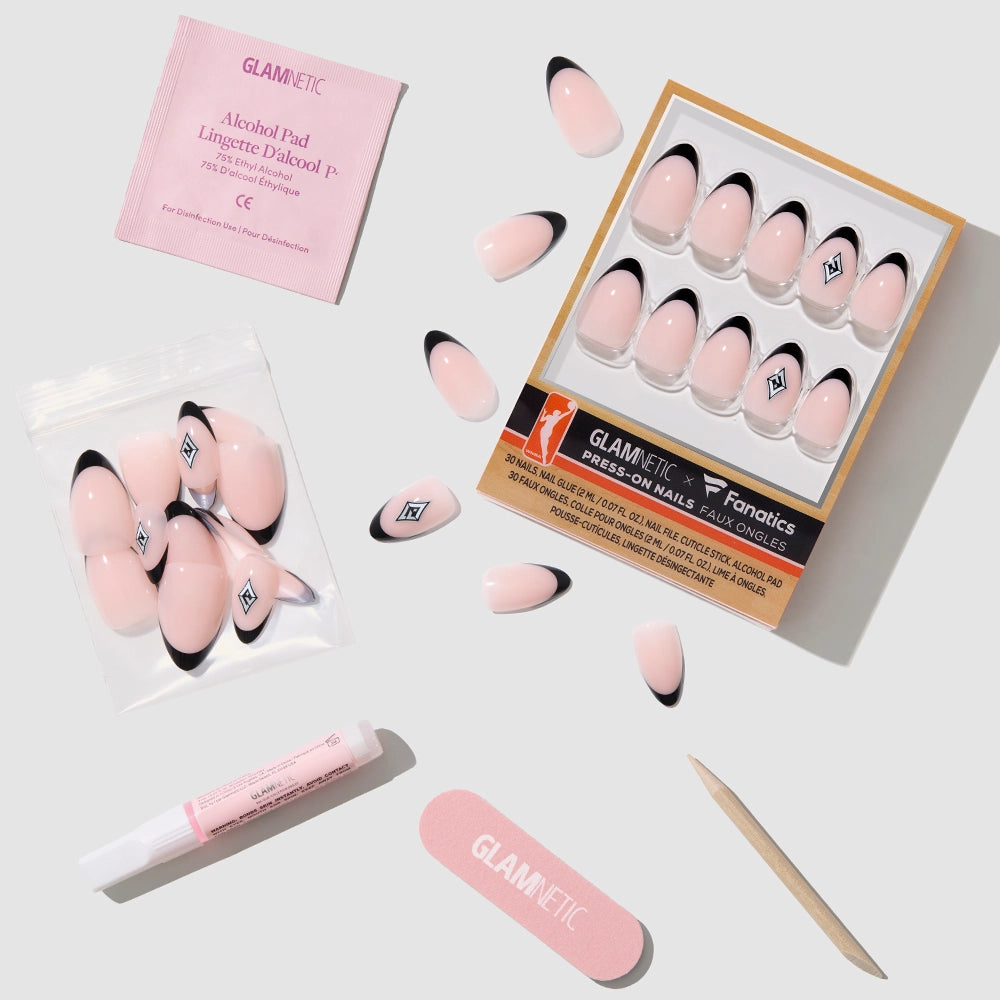 A flat lay of the glamnetic Las Vegas Aces Press-On Nail Set shows pink nails with black tips, a nail file, cuticle stick, glue, alcohol pad, and extra nails—everything needed for a salon-quality manicure on a light background. - Product image