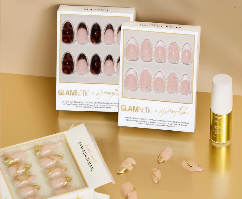 Glamnetic press-on nail sets with a glamzilla brush-on nail glue on a beige background