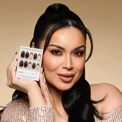 Woman holding a glamnetic's glamzilla press-on nail collection with a beige background