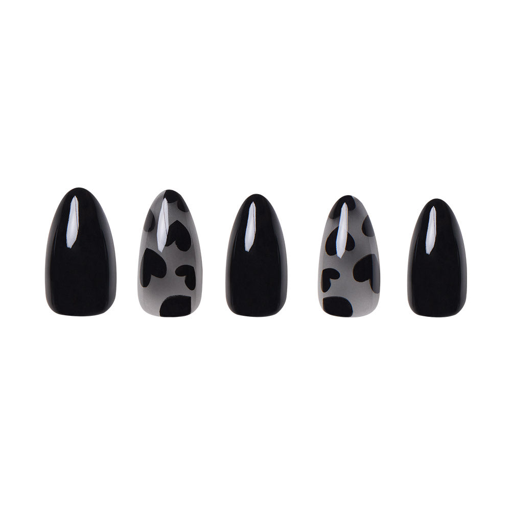 Five almond nails from glamnetics Love Me Not set are shown: three glossy black, two with black and clear heart and spot accents. The edgy romance designs are displayed upright against a white background. - Product image