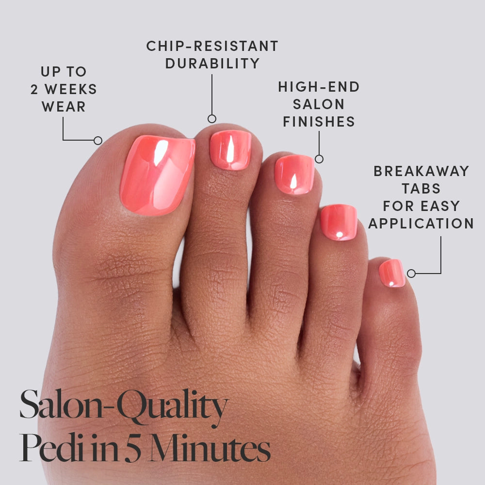 A close-up of toes with glossy Lush Coral nails by glamnetic. Text highlights up to 2 weeks wear, chip-resistant, vegan press-on toenails, and breakaway tabs for easy use. Caption: Salon-Quality Pedi in 5 Minutes. - Product image