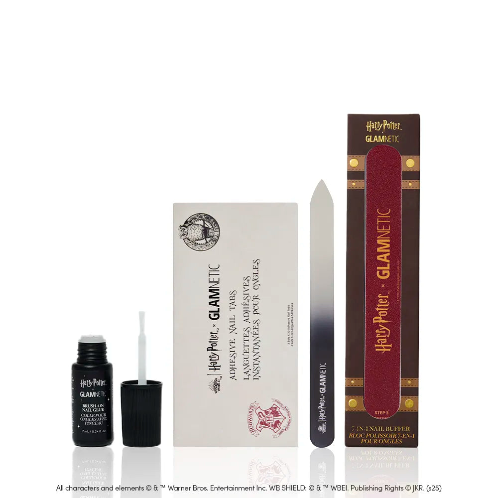 The glamnetic Magic Mani Must-Haves set includes Harry Potter press on nails, brush-on nail glue, a white envelope, glass nail file, and red emery board—all in magical, branded packaging.