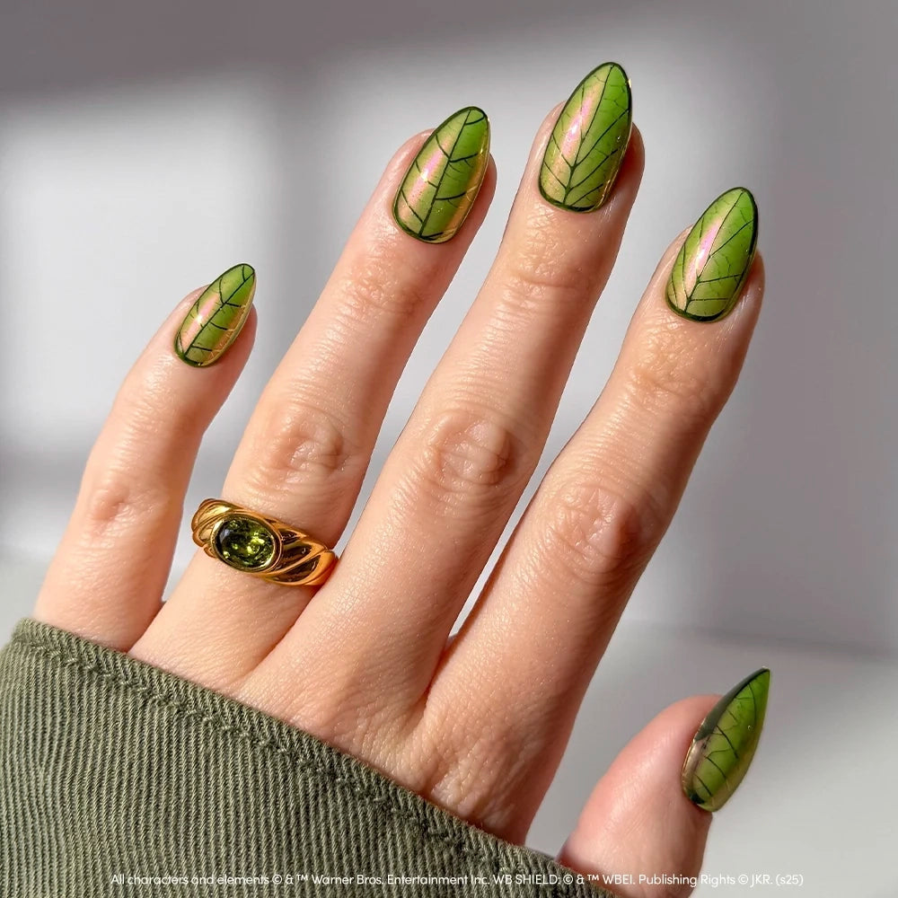Glamnetic Mandrake almond-shaped nails with a green iridescent finish and black leaf vein patterns.