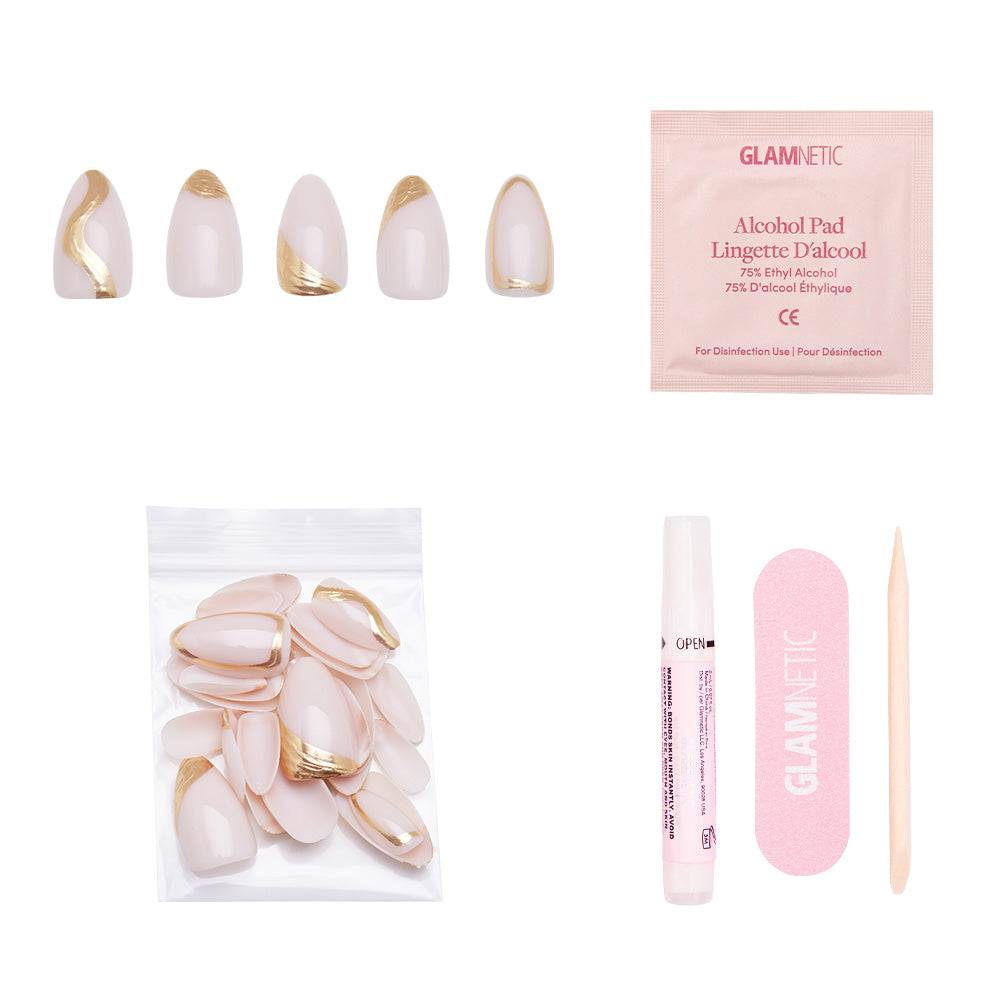 The glamnetic Material Girl Nail Set includes short almond press-ons with gold foil, an alcohol pad, extra nails, nail glue pen, pink file, and cuticle stick—all arranged on a white background. - Product image