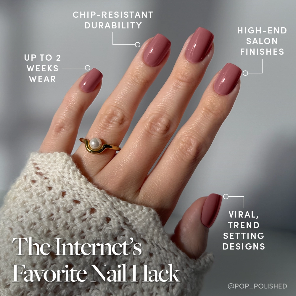 A hand with glamnetic’s Mauve On press-on nails, featuring a trendy short squoval shape and chip-resistant, high-end finish, wears a gold ring with a pearl and rests on a textured knit sleeve. Enjoy up to 2 weeks of flawless wear. - Product image