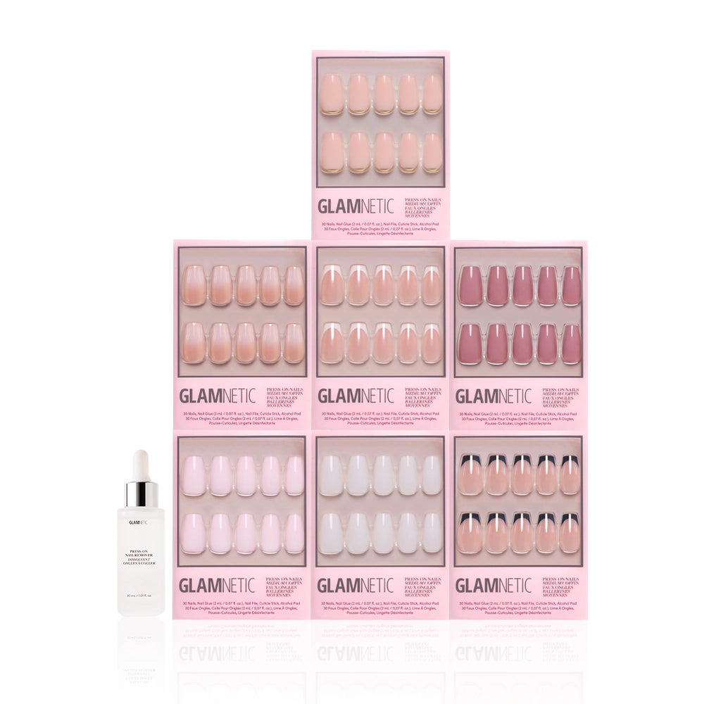 Seven boxes of glamnetic Medium Coffin Icons press-on nails in assorted pink and nude tones are stacked pyramid-style, with a glamnetic nail glue dropper bottle in front. The sleek, minimalist nail designs stand out against a white backdrop. - Product image