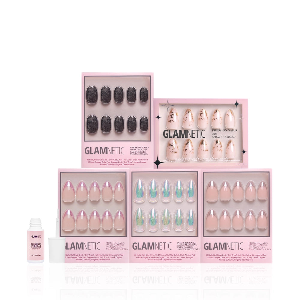 Five boxes of glamnetic’s Metallic Moments Bundle press-on nails, featuring metallic and chrome sets, are arranged in two rows with a small nail glue bottle in front, all displayed on a white background. - Product image