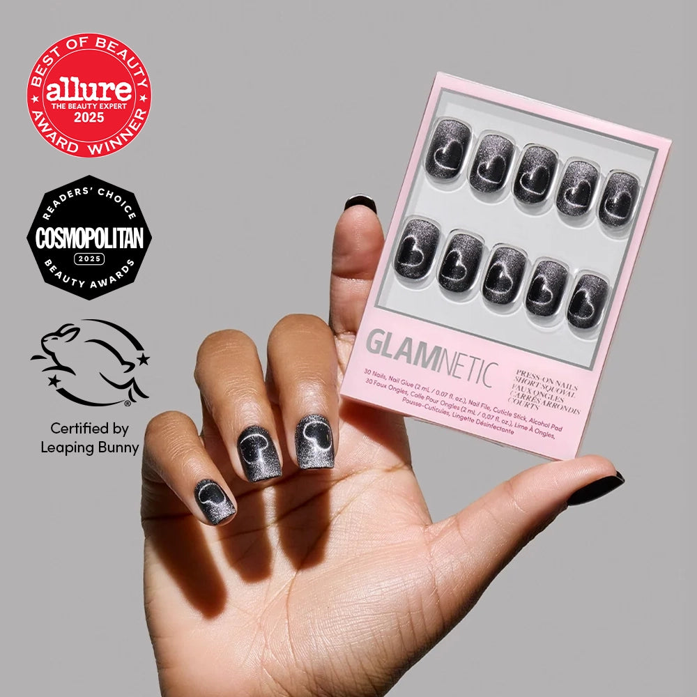A hand with short squoval Midnight Romance press-on nails holds a glamnetic nail set box. Allure, Cosmopolitan, and Leaping Bunny certification logos appear on the left.