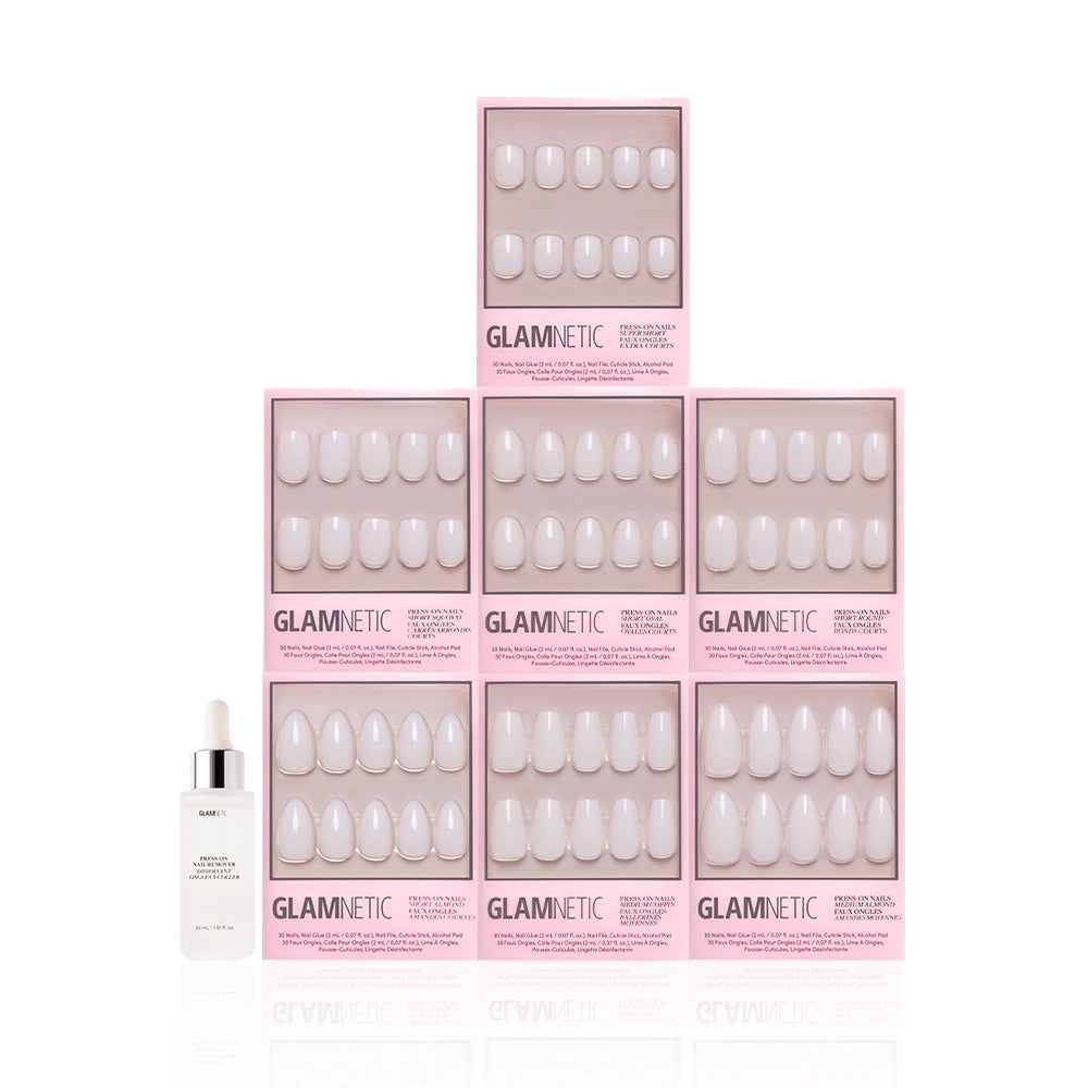 Nine pink boxes of the glamnetic Milky Manis Bundle are stacked in a pyramid, with a small white dropper bottle in front of the bottom left box, all arranged against a white background. - Product image