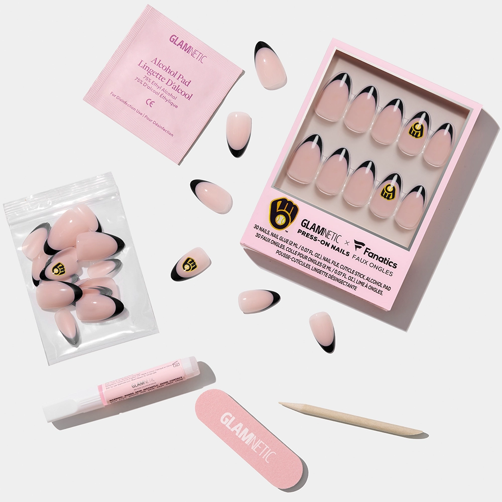 The glamnetic Milwaukee Brewers Press-On Nail Set features pink nails with black French tips and gold logo accents, plus an alcohol pad, glue, nail file, cuticle stick, and extra nails—all displayed on a white background. - Product image