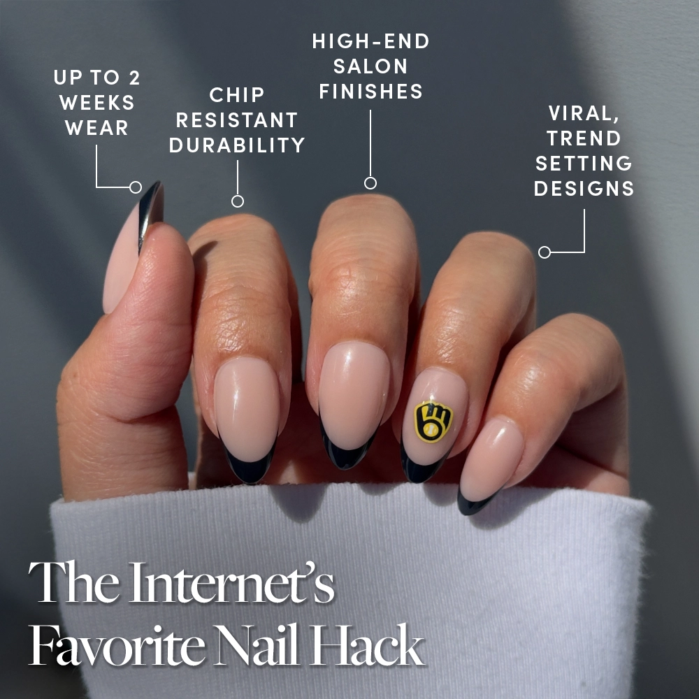 A hand sports glamnetic’s Milwaukee Brewers Press-On Nail Set with nude and black French tips plus a gold accent. Text touts up to 2 weeks wear, chip resistance, salon-quality finishes, trendy designs, and “The Internet’s Favorite Nail Hack.”. - Product image