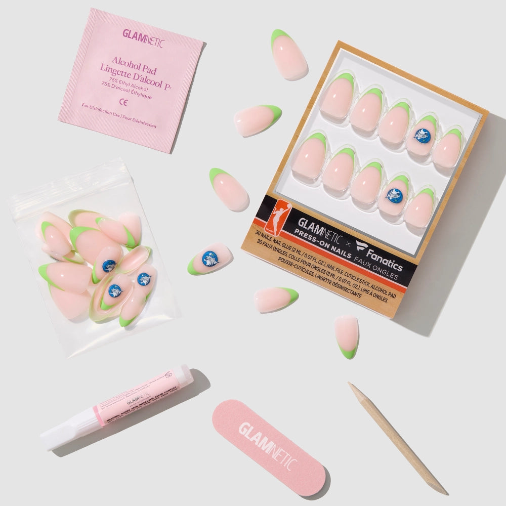 The glamnetic Minnesota Lynx Press-On Nail Set includes pink and green nails with a blue logo, plus an alcohol pad, nail glue, file, cuticle stick, and extra nails—all on a light gray background. Officially licensed. - Product image