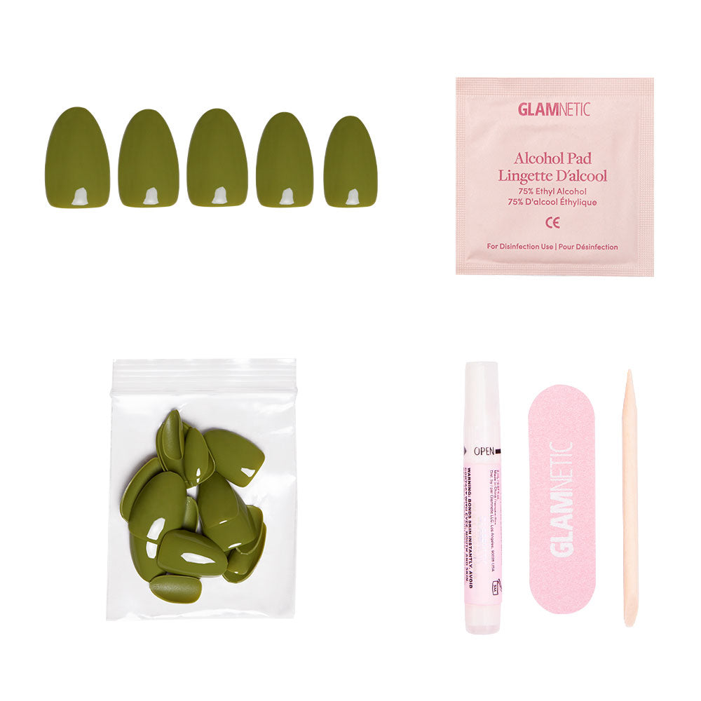 The glamnetic Moss Green set includes olive press-on nails, alcohol pad, extra nails, pink nail file, wooden cuticle stick, and glue—all arranged on a white background for the perfect fall look. - Product image