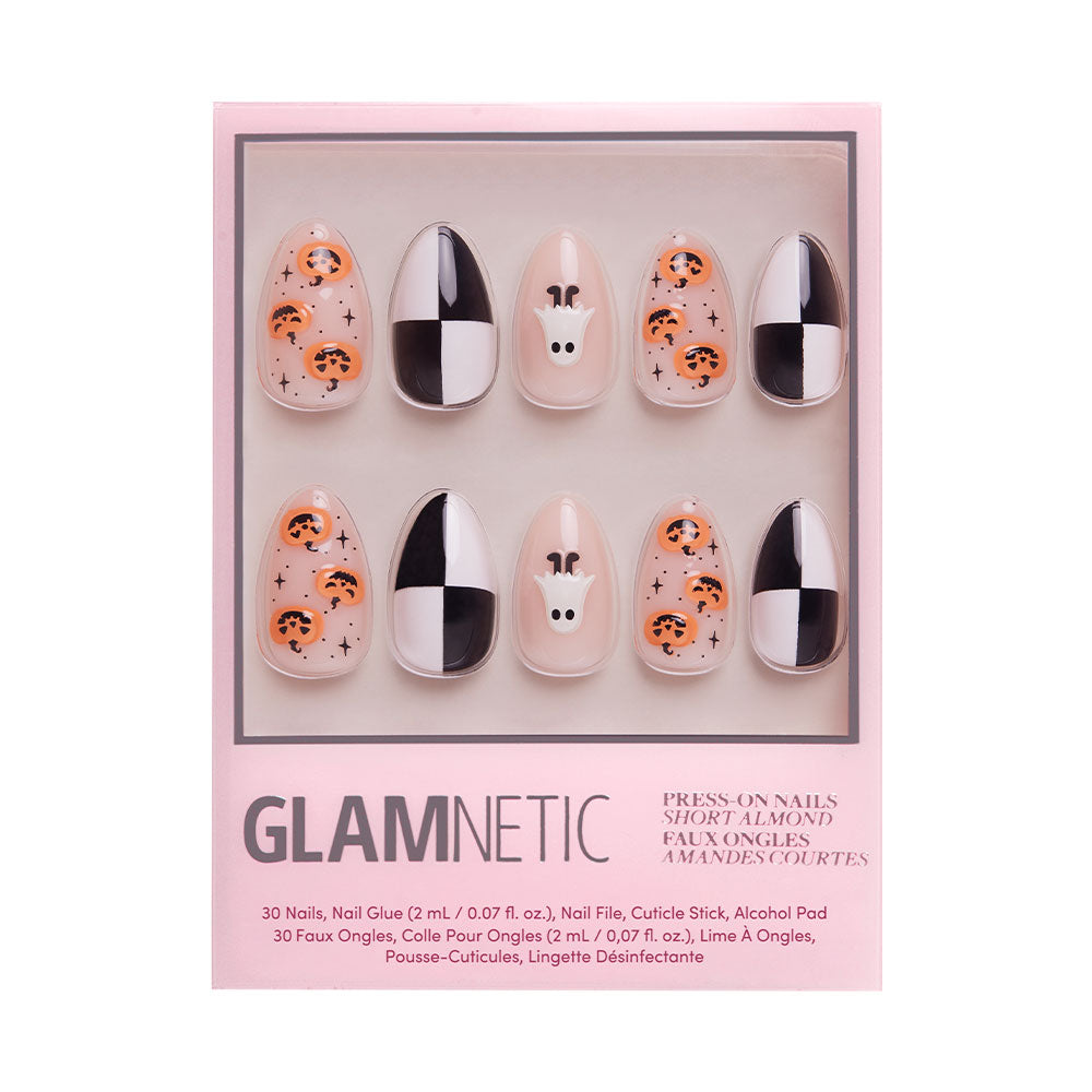 A box of glamnetic press-on nails in the My Boo set brings Halloween to life with designs like jack-o-lanterns, a ghost, black and white checker patterns, and sparkles on short almond-shaped nails.