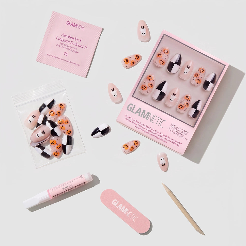 A set of glamnetic My Boo Halloween nails, featuring short almond press-on styles with pumpkin, ghost, and black-and-white designs. The kit includes glue, an alcohol pad, nail file, and cuticle stick—displayed on a light background. - Product image