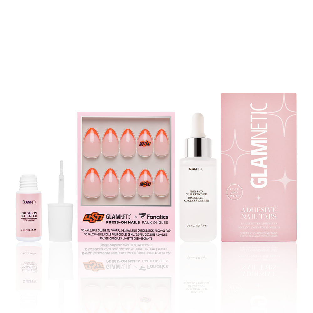 A set from glamnetic’s The Collegiate Gameplan Bundles featuring press-on nails with a pink and orange design, nail glue, a liquid adhesive bottle, and a pink box labeled Adhesive Nail Tabs, all arranged against a white background. - Product image