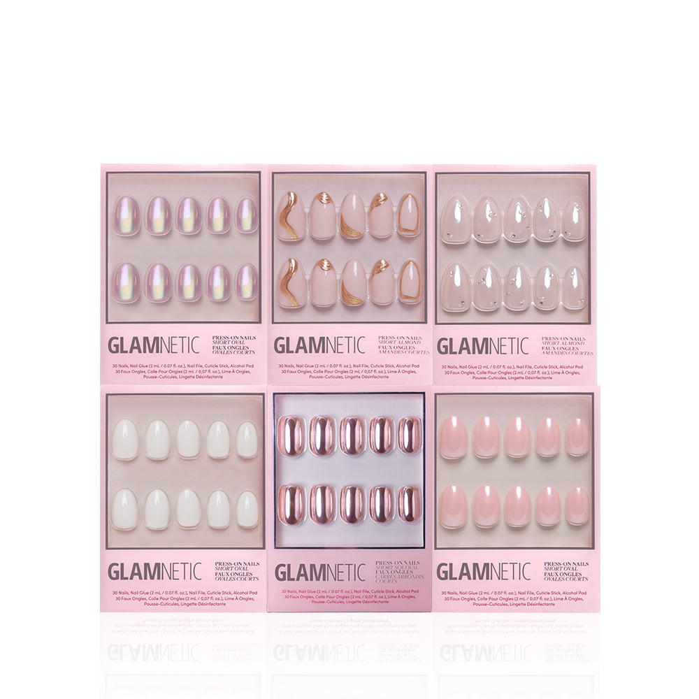 Six boxes of the glamnetic NYE Rendezvous Bundle are shown in two rows, each featuring a unique soft glam nail design in pink, white, nude, iridescent, and metallic rose gold shades with stylish patterns and finishes. - Product image