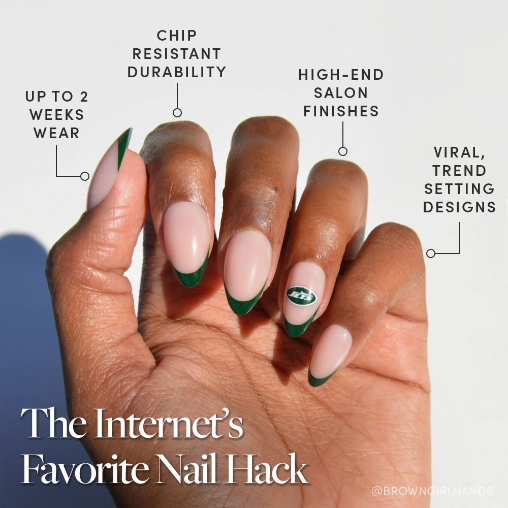 A hand with almond French tip nails shows a light pink base and green tips, plus a green leaf accent, showcasing glamnetic's New York Jets Press-On Nail Set. Text highlights its durability, trendy designs, and two-week wear for a chic Jets-inspired look. - Product image