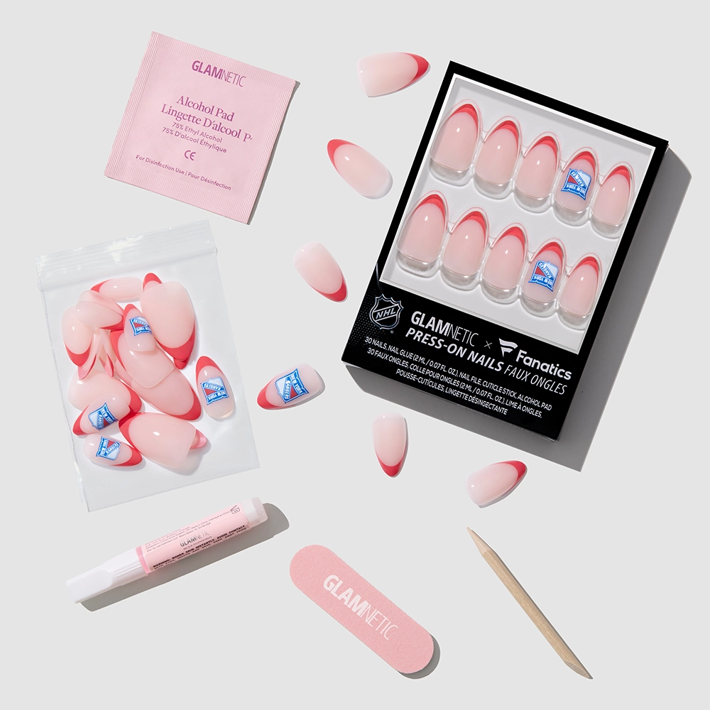 A flat lay of glamnetic’s New York Rangers Press-On Nail Set includes blue and red French tip nails, nail glue, a file, cuticle stick, an alcohol pad, and extra nails—perfect for Rangers fans wanting stylish team-themed tips. - Product image