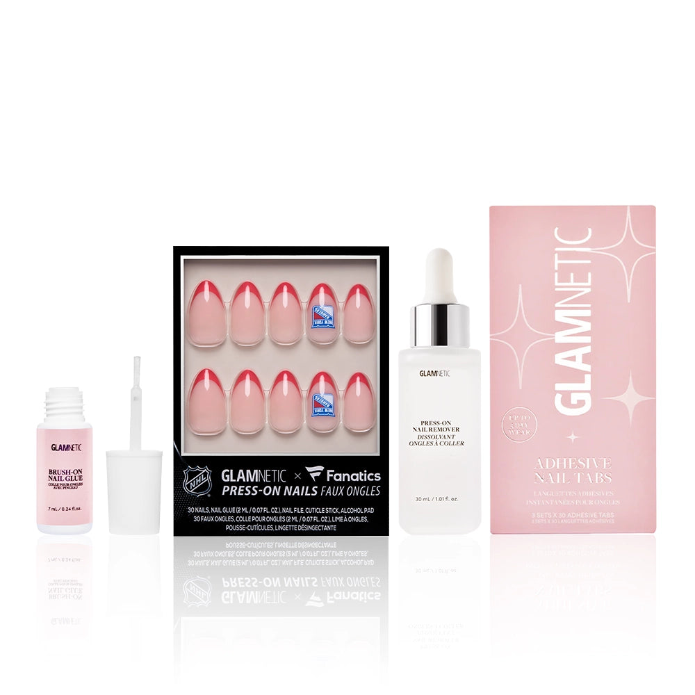 Glamnetic’s The New York Rangers Lineup includes NHL-licensed press-on nails with pink and red French tips, a pink adhesive bottle, clear liquid glue, and GLAMNETIC Adhesive Nail Tabs—all in a stylish black box.