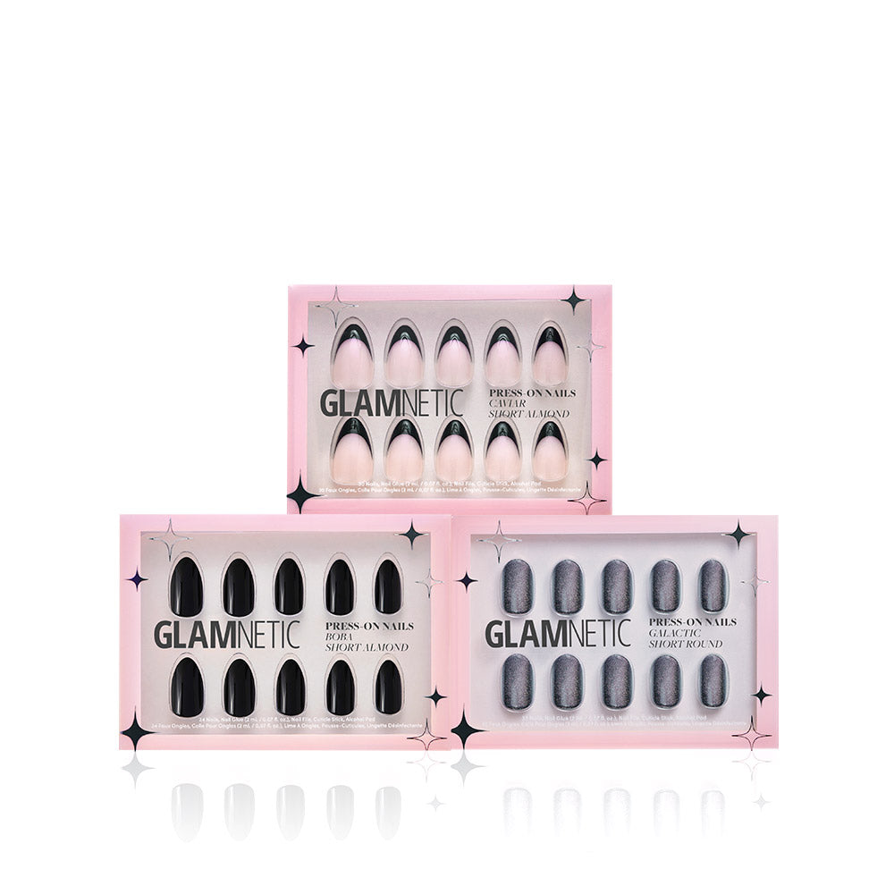 Three boxes of glamnetic Noir Classics press-on nails are shown: light pink almond, black almond, and sparkly gray round, all in pink packaging—ideal for pairing with Brush On Glue for quick, easy application.