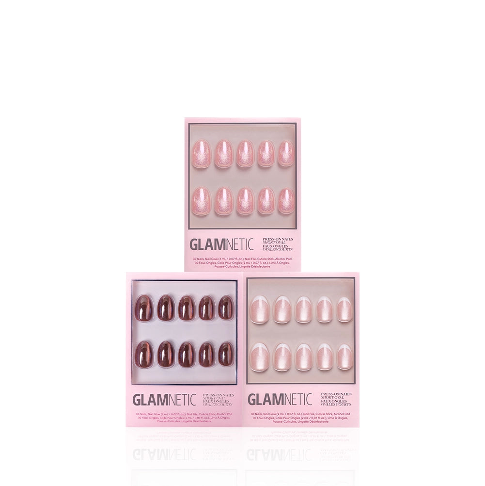 Three boxes of glamnetic Oval Extra Credit press-on nails are arranged in a triangle on a white background. Each box displays a different pink or burgundy shade and shape through a clear front window, showcasing salon-quality nails perfect for any occasion. - Product image