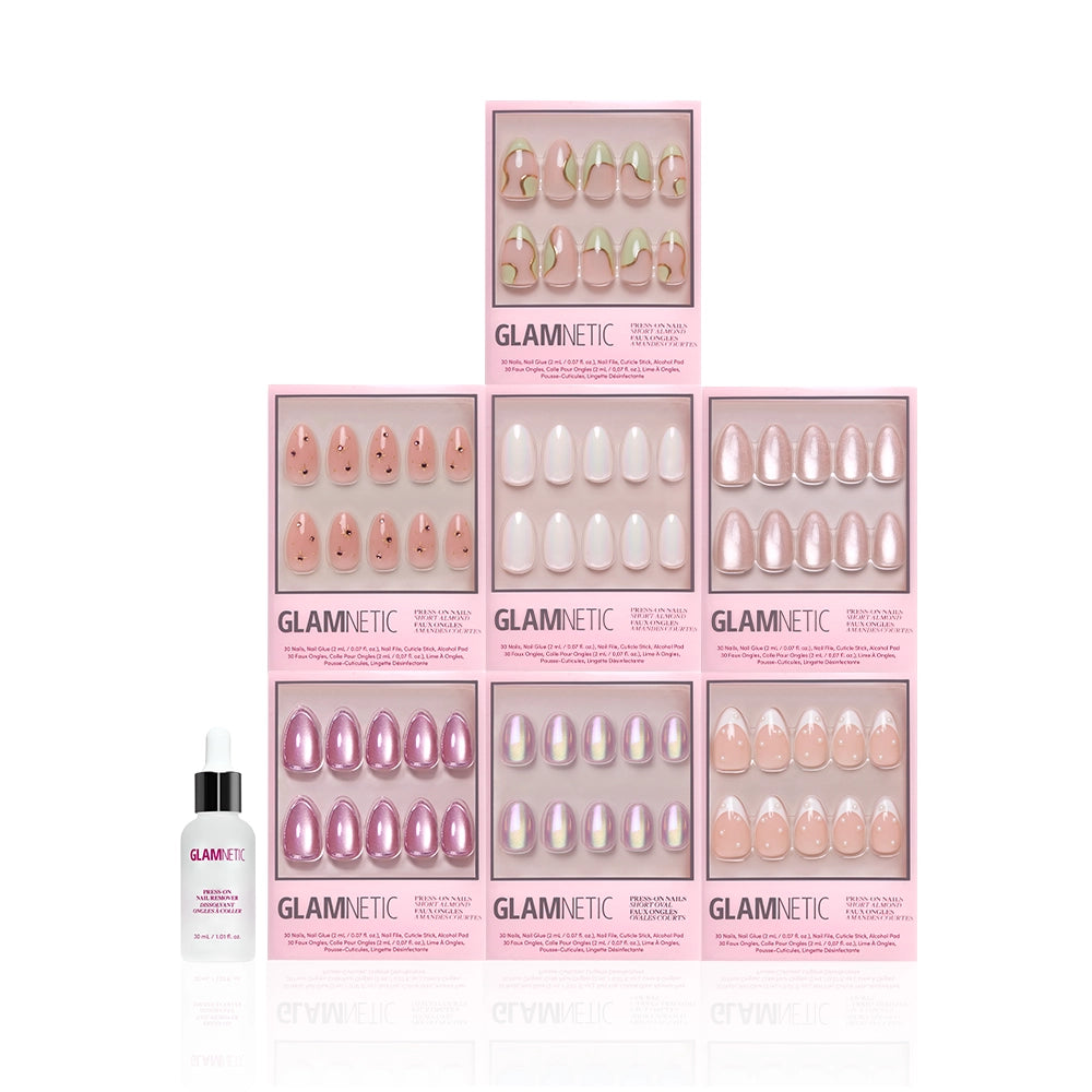 Six boxes of glamnetic Desert Muse salon-quality nail sets in pink and nude designs are arranged in a pyramid, with a bottle of glamnetic cuticle oil placed in front on a white background. - Product image