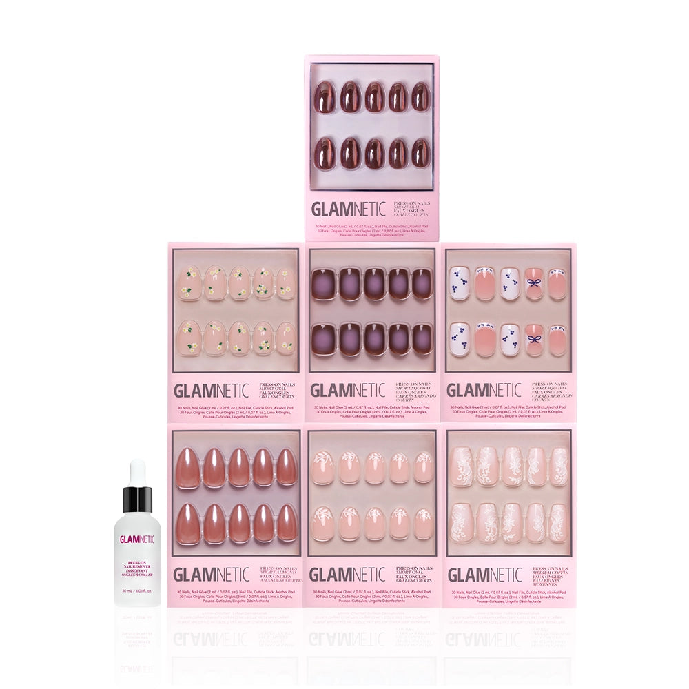 Seven boxes of glamnetic Rodeo Darling nail sets in assorted colors and designs are stacked in a pyramid, with a glamnetic cuticle oil bottle in front on a white background—ideal for salon-quality manicures at home. - Product image