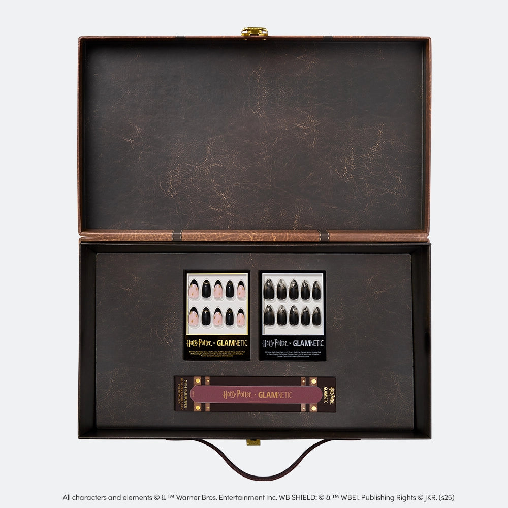 The glamnetic Harry Potter™ x Glamnetic PR Box features two sets of Harry Potter press-on nails and a nail file, all neatly arranged in an open brown box with branded packaging—perfect for any fan’s collection.