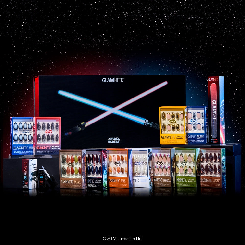 A set of salon-quality STAR WARS™ press-on nails from glamnetic is displayed in front of the limited edition STAR WARS™ | Glamnetic PR Box, which features two crossed lightsabers against a starry background.