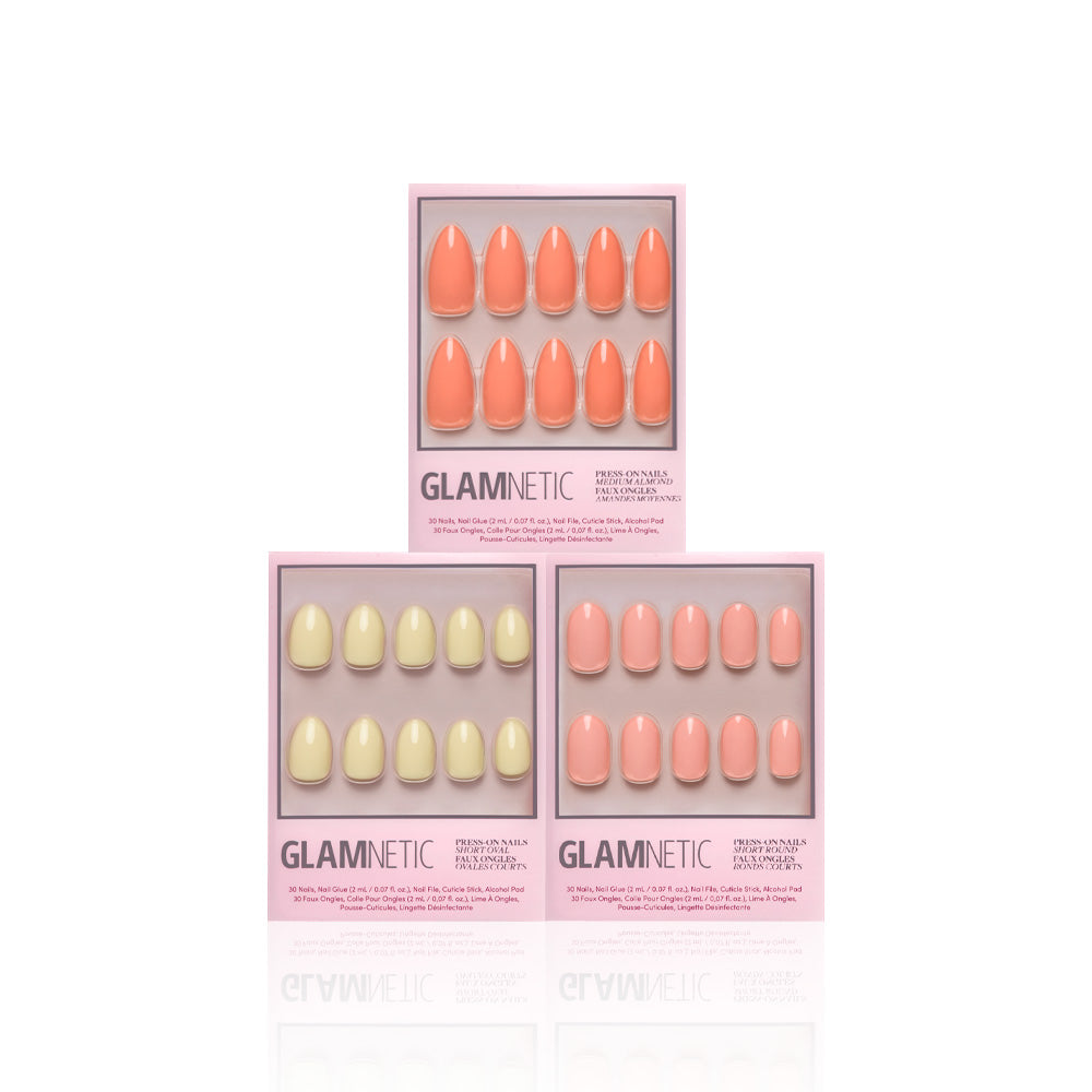 Three glamnetic Pastel Paradise press-on nail boxes in pastel pink and peach, stacked pyramid-style on a white background. Each box displays salon-quality, oval-shaped nails through a clear window. - Product image