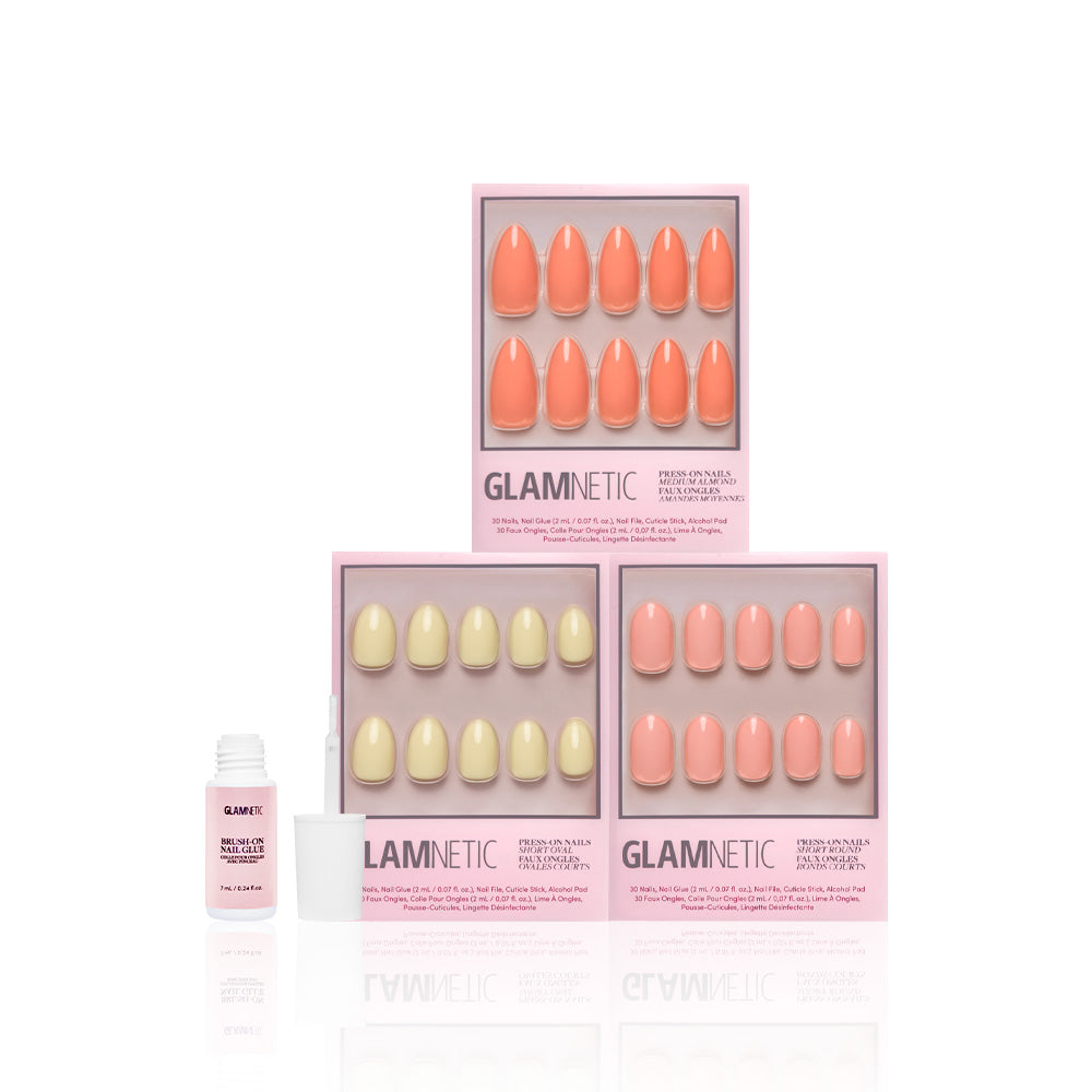 Three packs of glamnetic Pastel Paradise press-on nails in peach and light yellow, featuring salon-quality thickness, are displayed with an open nail glue bottle on a white background. - Product image