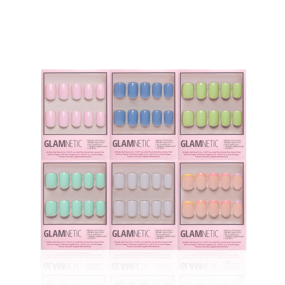 Six packs of Glamnetic Squoval Pastel Palette press-on nail sets are arranged in two rows. Each set features pastel nails in pink, blue, green, mint, gray, and peach shades—all showcased in stylish pink-bordered packaging. Some packs highlight trendy French tips for a chic finish. - Product image