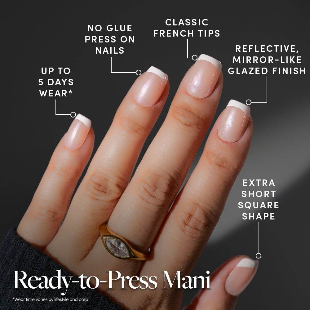 A hand with short, square, glazed Pearl Du Jour press-on nails by Glamnetic, with text callouts detailing benefits like five-day wear and no-glue application. - Product image
