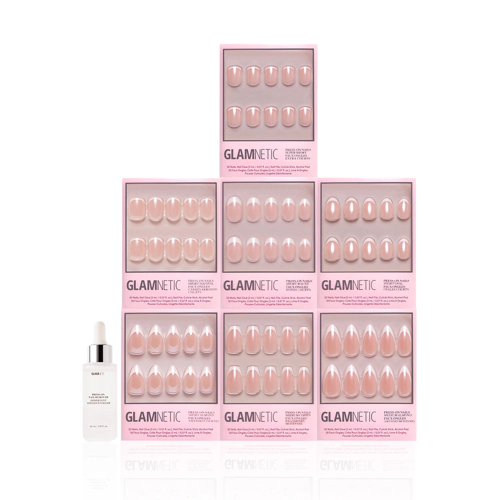 A dropper bottle stands beside a pyramid of nine pink Pearl Posse Bundle boxes by glamnetic, each containing pearlescent press-on nails, all arranged against a white background. - Product image