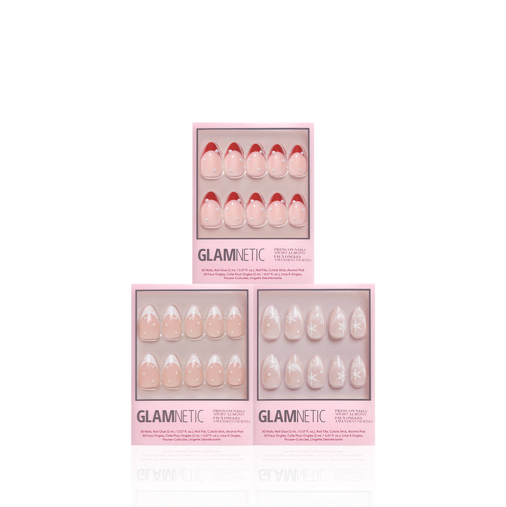 Pearls Under the Tree - Glamnetic Pearls Under the Tree includes three boxes of short almond press-on nails: one set with red French tips, one with a classic French manicure, and one with a white snowflake design.
