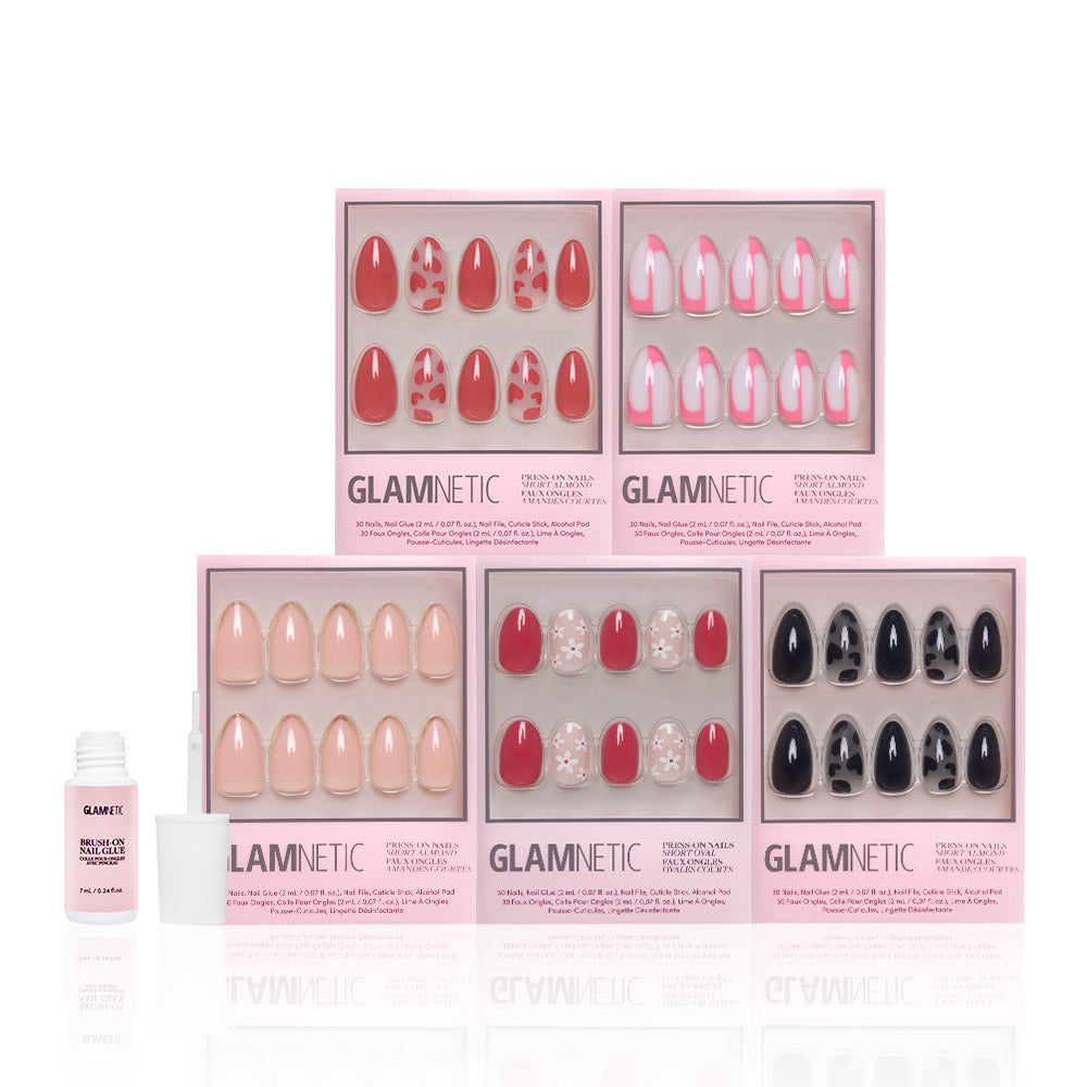 Six boxes of glamnetic Perfect Match short almond press-on nails in assorted colors and patterns are arranged in two rows, with a bottle of nail glue and cap on the left. These reusable nails provide effortless style and convenience. - Product image