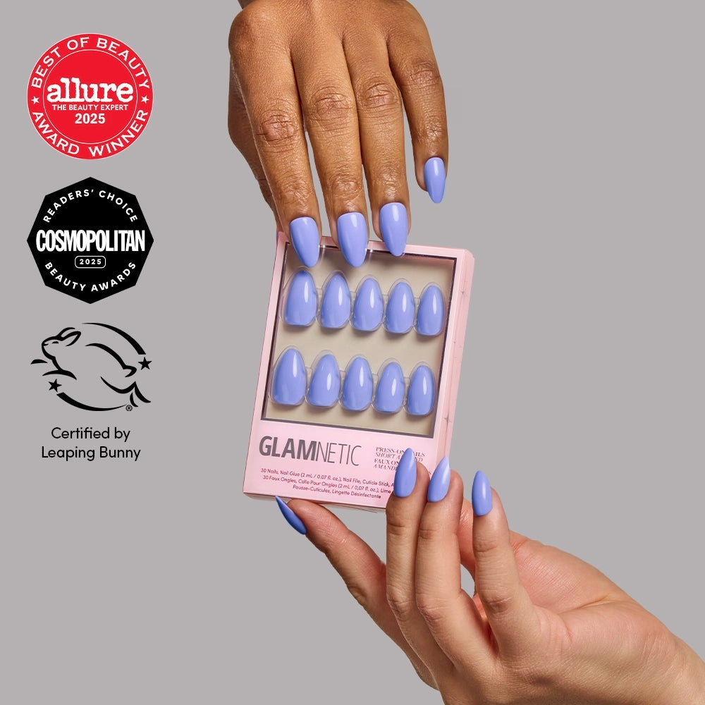Hands holding a pink box of Periwinkle glamnetic short almond press-on nails, surrounded by Allure, Cosmopolitan, and Leaping Bunny award logos.
