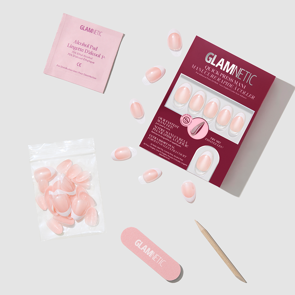 Petite Pearls extra short, pink and white glazed French-tip press-on nails, shown with their box, spare nails, alcohol prep pad, nail file, and cuticle pusher. - Product image