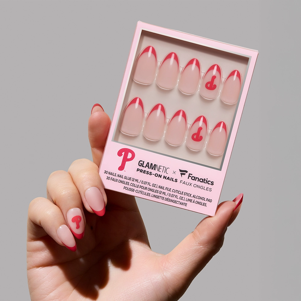 A hand holds the glamnetic Philadelphia Phillies Press-On Nail Set, featuring pink French tips and P accents—ideal for baseball nail art fans.