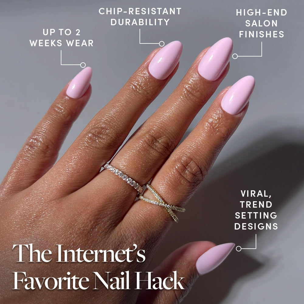 A hand with glossy, short almond Pink Poise press-ons by glamnetic, wearing two rings, shows manicured nails. Features: up to 2 weeks wear, chip-resistant durability, high-end salon finish, and viral trend-setting designs. - Product image