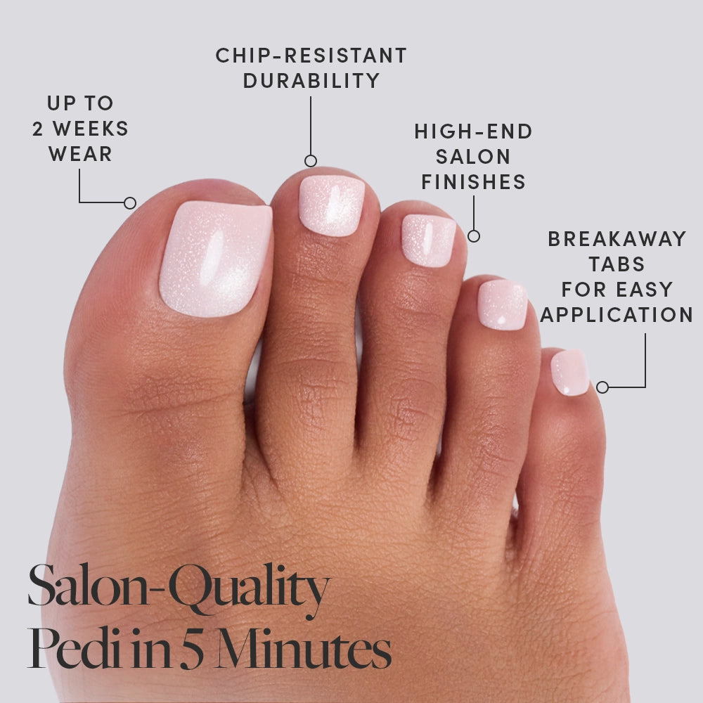 A close-up of a foot with light pink Pinky Promise Toenails by glamnetic highlights 2-week wear, chip-resistant durability, salon-quality finish, and easy breakaway tabs. Text: Salon-Quality Pedi in 5 Minutes. - Product image