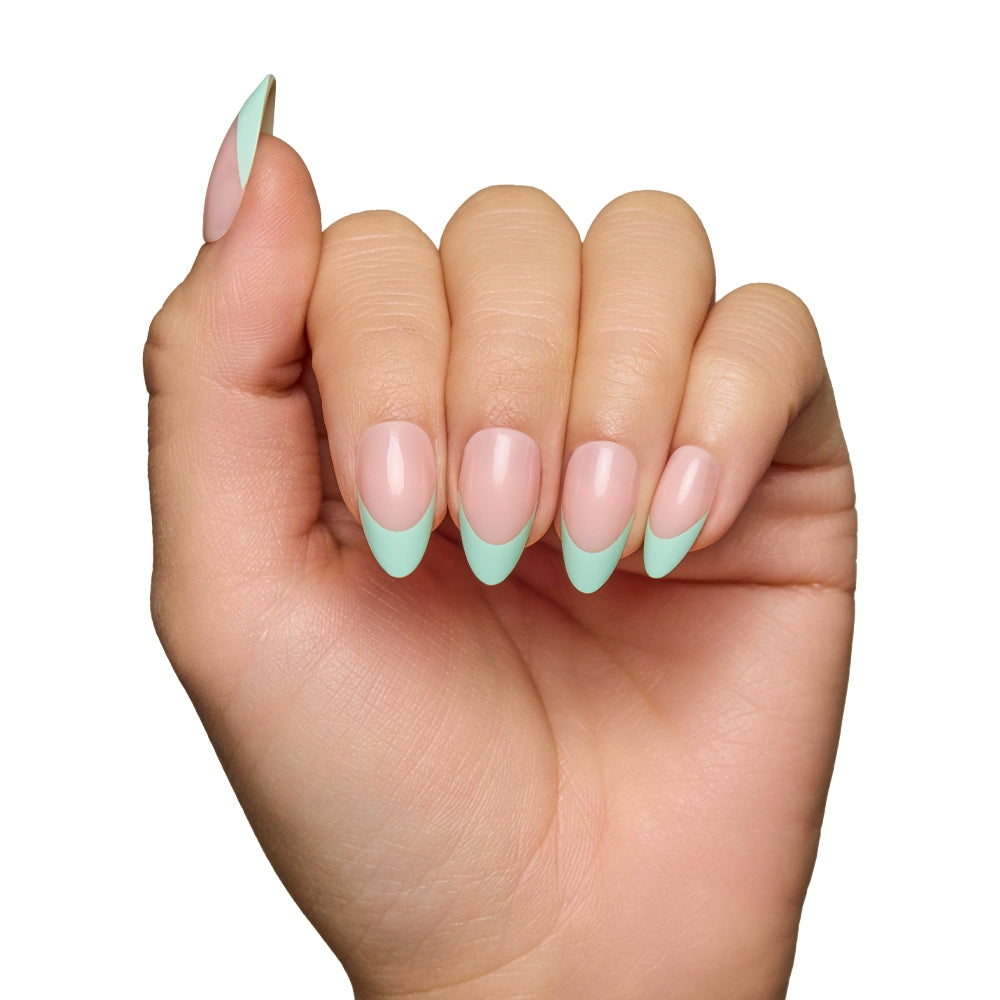 A hand with almond-shaped glamnetic Pistachio Crème press-on nails, featuring pale pink bases and light mint green French tips for a modern, salon-quality look, is shown against a white background. - Product image