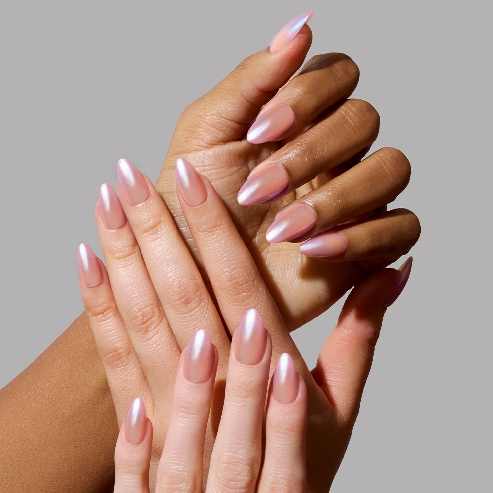 Two hands with short almond nails in glamnetics Polar Day, a pearlescent pink-to-white gradient set, posed on a gray background—ideal for minimalist nail lovers. - Product image