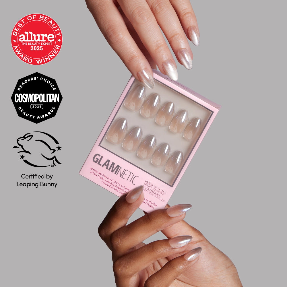 A hand holds a box of glamnetic press-on nails in the Polar Night style, while another hand displays short almond-shaped, metallic nails. Multiple beauty award logos appear on the left side of the image. - Product image