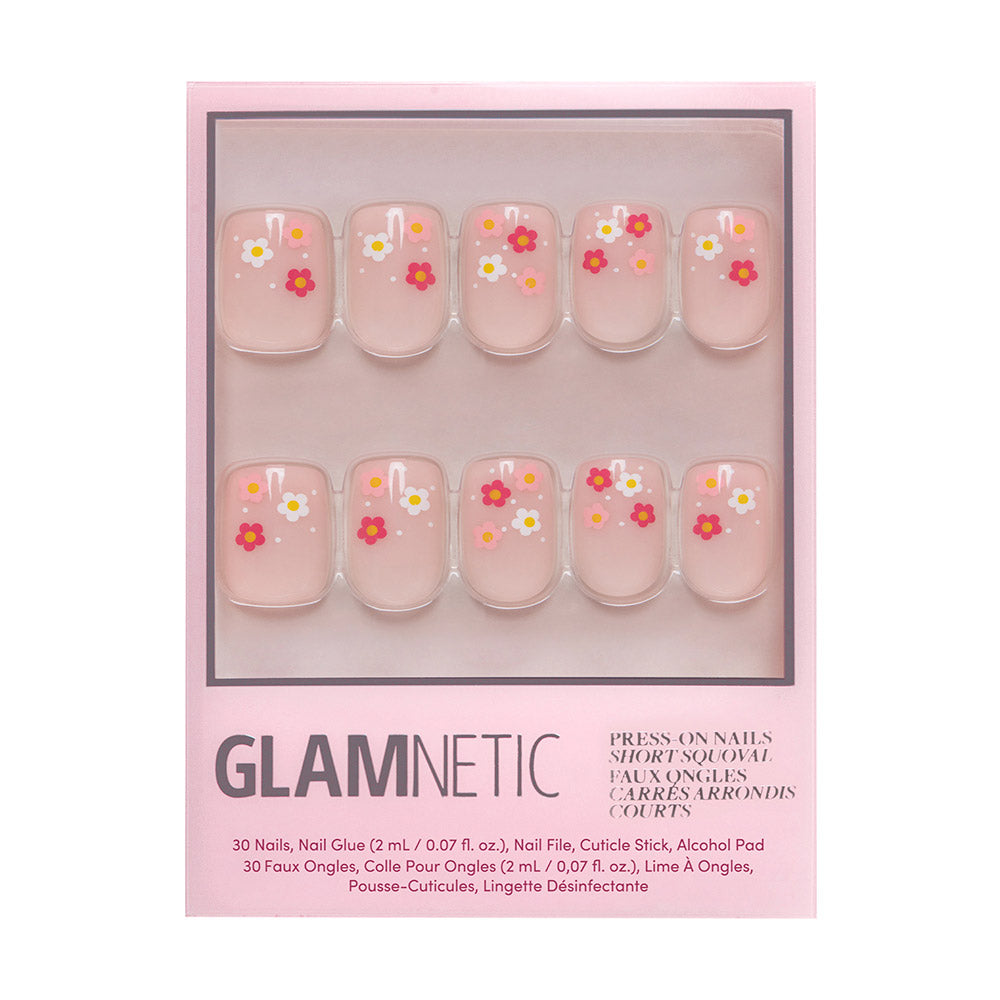 The glamnetic Pretty Bloom set features short squoval press-on nails in glossy light pink, each with colorful floral French tips in red, white, and orange. Packaged beautifully with a pink border.